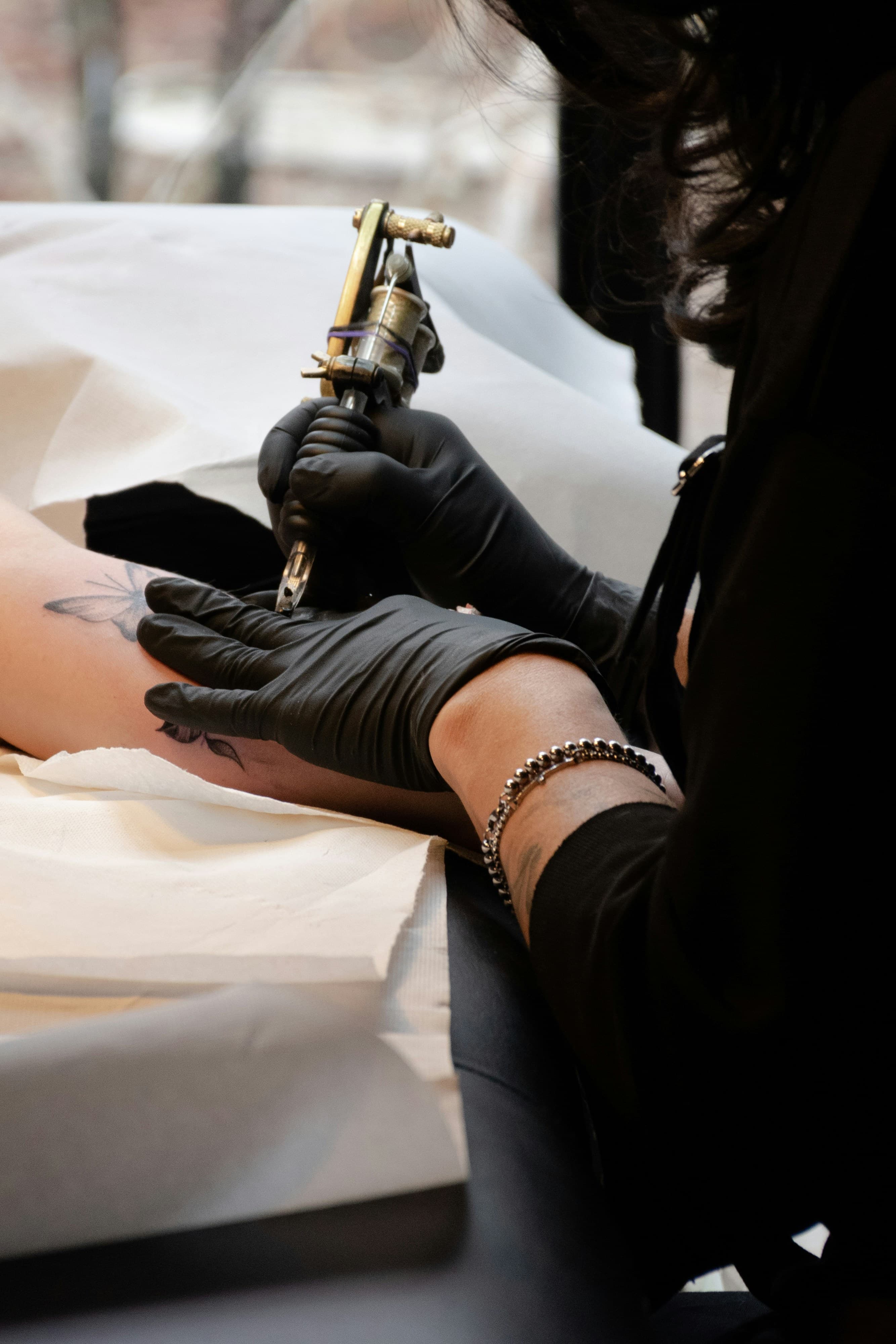 Tattoo artist working with a tattoo machine