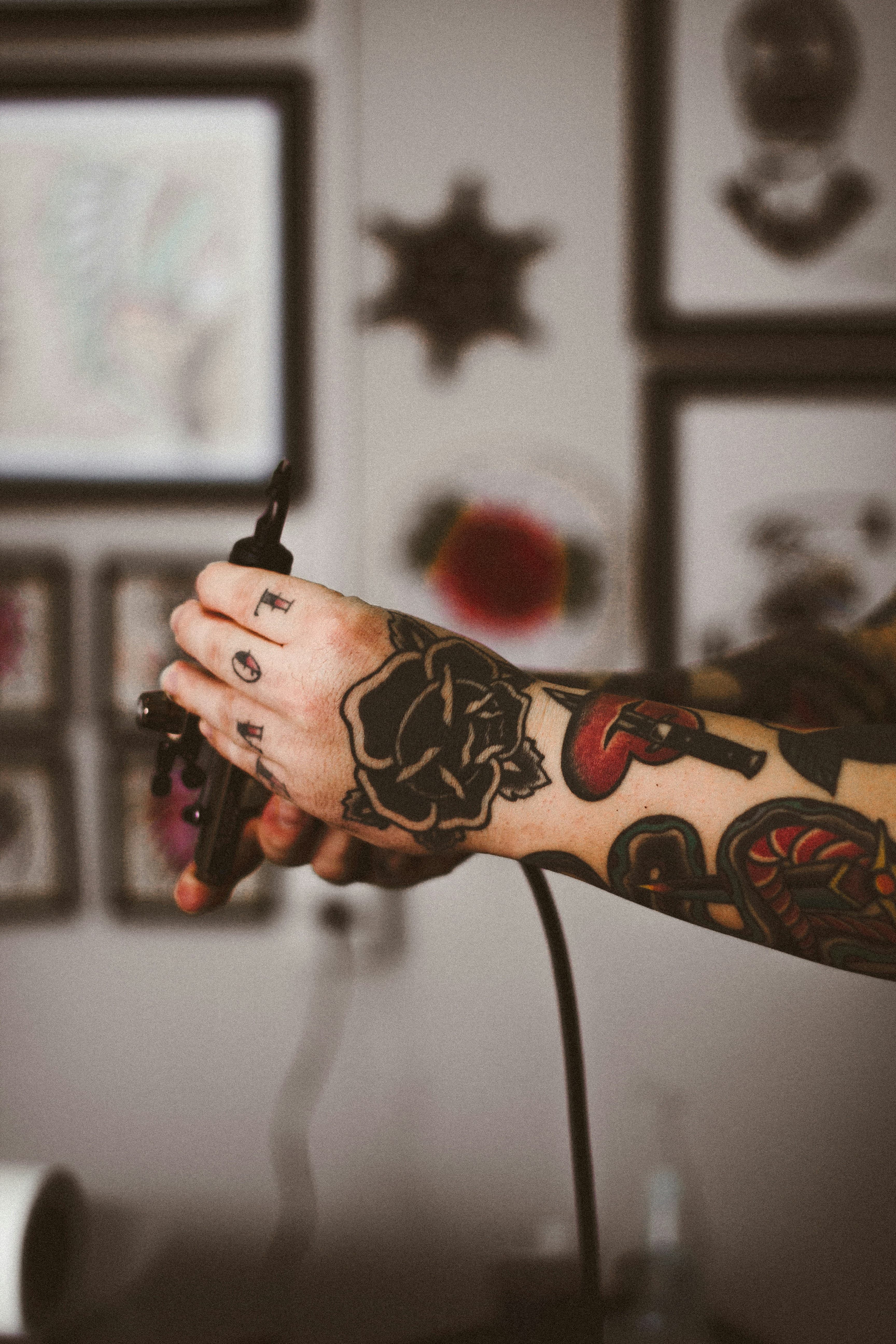 Black rose tattoo on a forearm